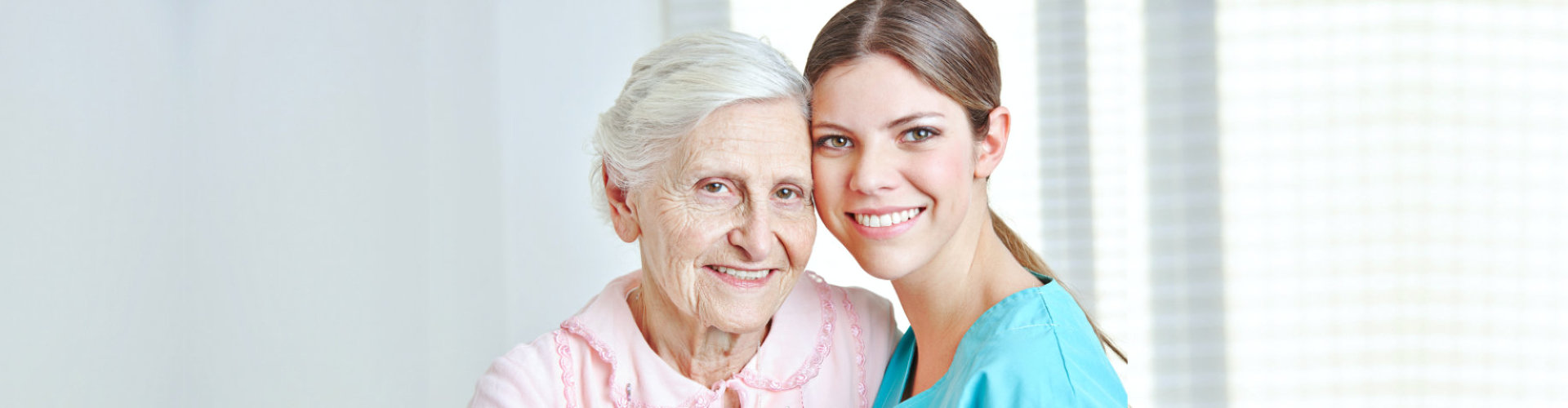 caregiver and senior woman smiling