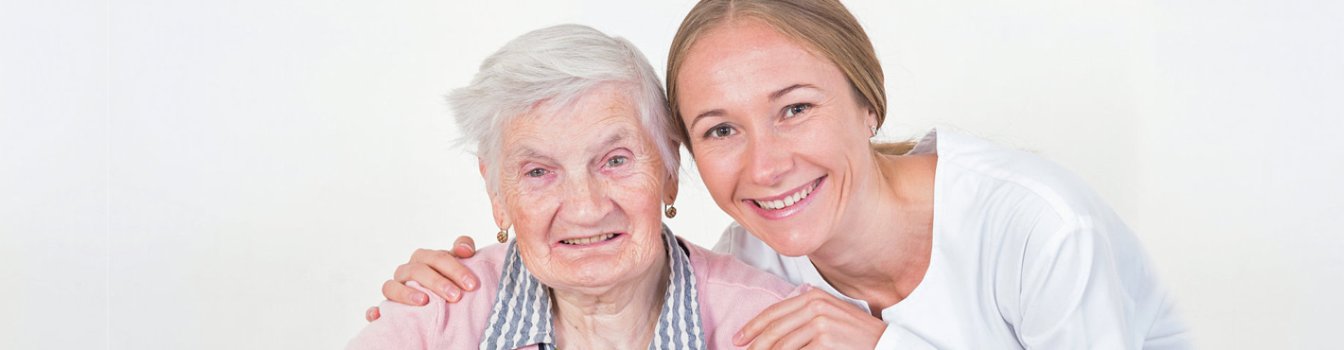 caregiver and senior woman are smiling